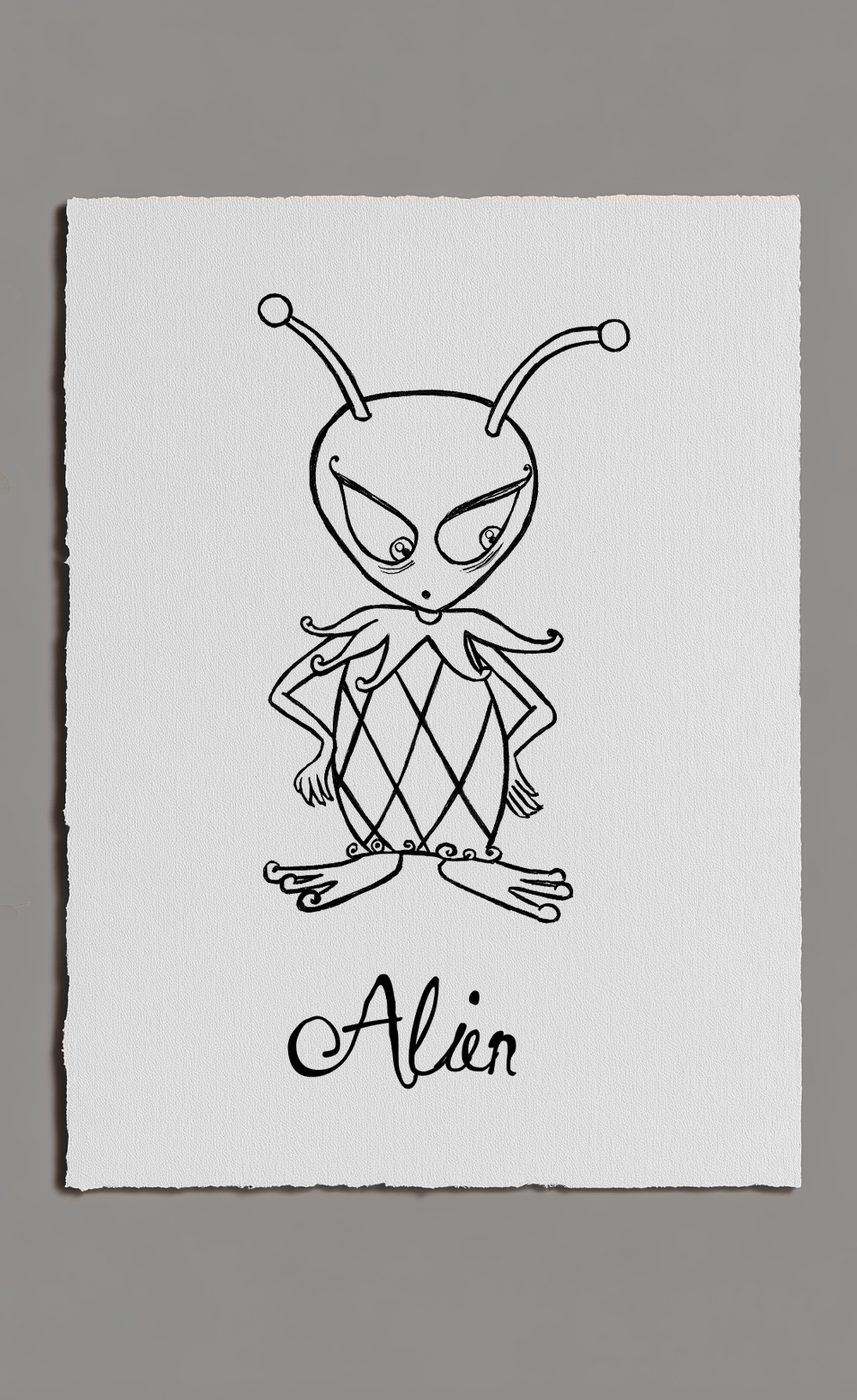 Black line drawing of an alien on white paper with 'Alien' text, against a gray background
