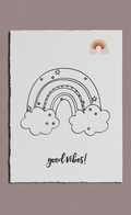 Poster with a black outline of a rainbow and clouds, 'good vibes!' text, and a colorful rainbow sticker on a white background.
