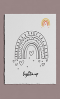 White card with black rainbows and hearts design, featuring a yellow rainbow at the top on a beige background.